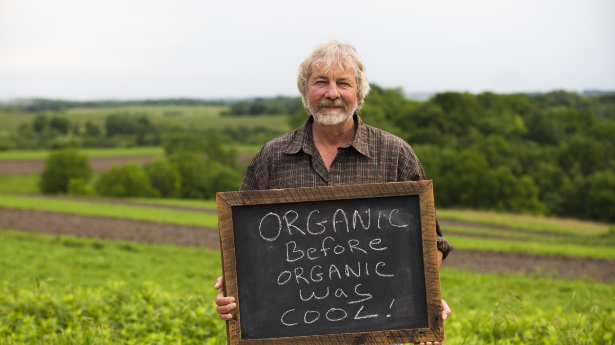 Amy's man holding organic sign